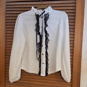 blouse with ruffled neckline and lace trim